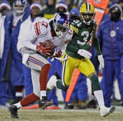 
Giants' Plaxico Burress had 1,025 receiving yards this year, but Patriots led NFL with 295.7 yards passing per game.Associated Press
 (Associated Press / The Spokesman-Review)