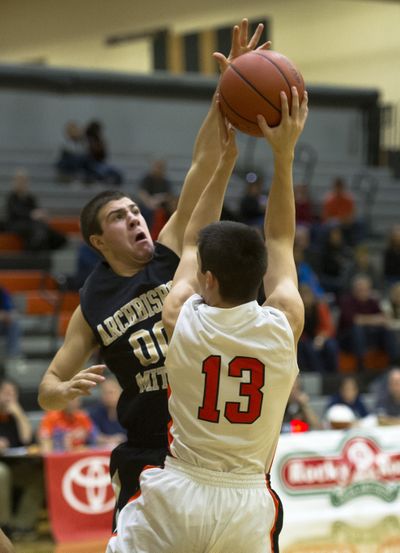 Archbishop Mitty’s Cameron Korb, left, blocks a shot by Lewis and Clark’s Julian Welge. (Colin Mulvany)