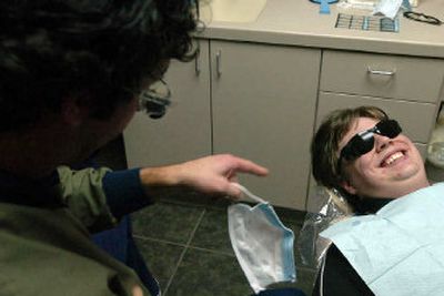 
Patient Daniel Monteleone, 16, grins up at Dr. Ken Bevan from the dentist's chair Friday, as he was getting a lecture about taking care of his teeth. Friday's free dental care program helps many children, Bevan said, but it doesn't put a dent in the overall need. 
 (Jesse Tinsley / The Spokesman-Review)