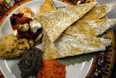 
A typical platter at Wild Sage might include crackers, red pepper spread, hummus and olive tapenade. 
 (Photos by Jed Conklin / The Spokesman-Review)