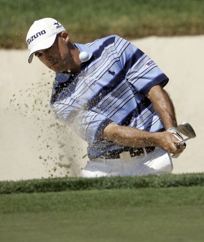 Jonathan Byrd chips out of a bunker on to the 10th green during the second round of the Memorial golf tournament.  (Associated Press / The Spokesman-Review)
