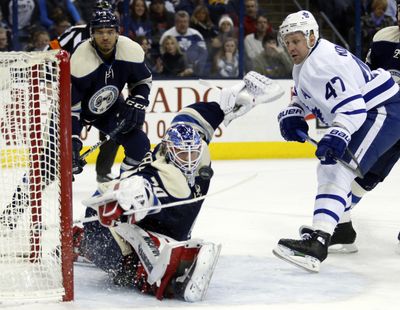 Columbus Blue Jackets goalie Joonas Korpisalo, of Finland, stops a shot against Toronto Maple Leafs forward Leo Komarov, right,, of Estonia, as Blue Jackets defenseman Seth Jones defends during the first period of an NHL hockey game in Columbus, Ohio, Wednesday, Feb. 15, 2017. (Paul Vernon / Associated Press)