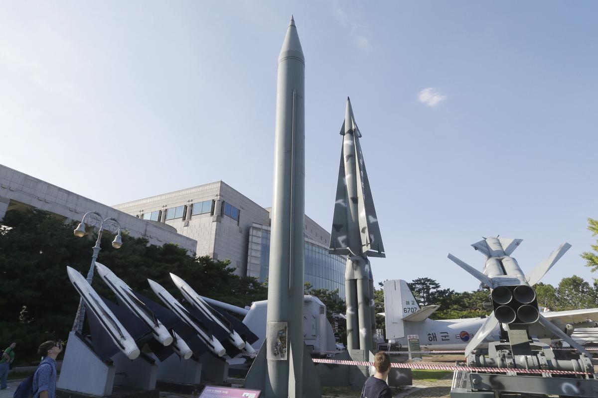 Visitors looks at models of North Korea
