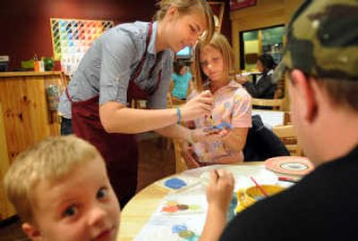 
Savannah and Jack Stierle, 8 and 4, of Newport, Wash., work on artwork with their parents and Patricia Swanson at Color Me Mine.  
 (Rajah Bose / The Spokesman-Review)