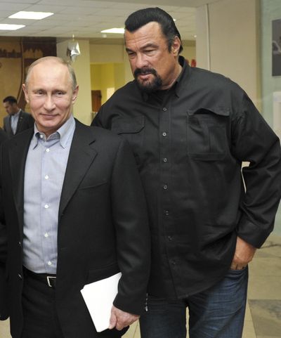 In this file photo taken on Wednesday, March 13, 2013, Russian President Vladimir Putin, left, and U.S. movie actor Steven Seagal visit a new sports arena in Moscow. Putin has awarded Russian citizenship to Seagal, the Kremlin said Thursday. (Alexei Nikolsky / Associated Press)