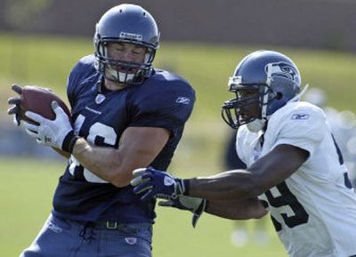 
Seattle Seahawks tight end Will Heller, formerly with the Tampa Bay Buccaneers, hauls in a pass against Kevin Hobbs during practice earlier this month. 
 (Jim Bryant Associated Press / The Spokesman-Review)