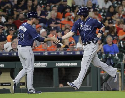 Tampa Bay’s C.J. Cron is congratulated by third-base coach Matt Quatraro after hitting a home run against the Astros Tuesday night in Houston. (David J. Phillip / Associated Press)