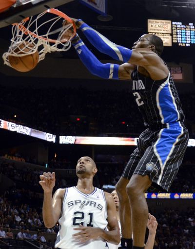 Dwight Howard, who told Orlando officials he won’t surrender his free-agent rights, dunks on San Antonio’s Tim Duncan. (Associated Press)