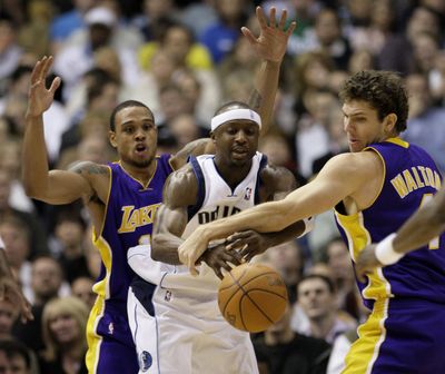 Lakers forward Luke Walton, right, strips the ball from Mavericks guard Jason Terry as Lakers guard Shannon Brown looks on.  (Associated Press)