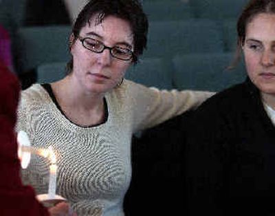 
Megan Cuilla, left, and Katharine Isserlis light candles during an  event sponsored by the Faith in Action Committee and Planned Parenthood of the Inland Northwest on Sunday. 
 (Liz Kishimoto / The Spokesman-Review)
