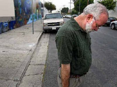 
Rev. Gregory Boyle, founder of Homeboy Industries, stands near the spot where an employee removing graffiti was gunned down Thursday in the Boyle Heights area in Los Angeles. 
 (AP photo/ Brian Vander Brug, Los Angeles Times / The Spokesman-Review)