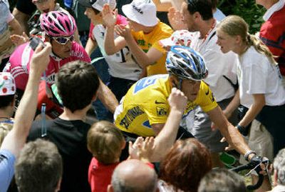 
Spectators urge overall leader Lance Armstrong, at right with yellow jersey, during the 8th stage of the Tour de France.
 (Associated Press / The Spokesman-Review)