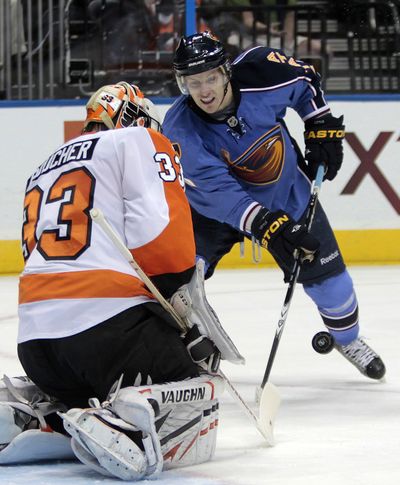Philadelphia Flyers goalie Brian Boucher blocks a shot from Atlanta center Bryan Little during the Thrashers’ win. (Associated Press)