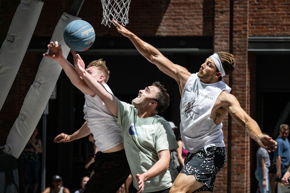 Flagrant Four’s Ryan Davidson, center, has his shot blocked by Sorlie’s Micah Pittsley, on left, and Dominique Holt, on right, during their Hoopfest game, Saturday, June 24, 2023, in downtown Spokane.  (COLIN MULVANY/THE SPOKESMAN-REVIEW)
