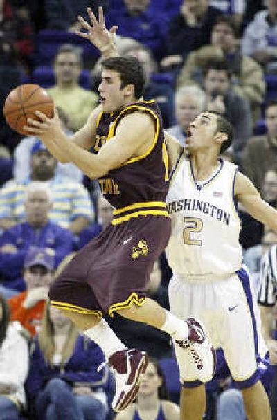 
Arizona States' Derek Glasser, left, passes the ball under pressure from UW's Adrian Oliver. 
 (Associated Press / The Spokesman-Review)