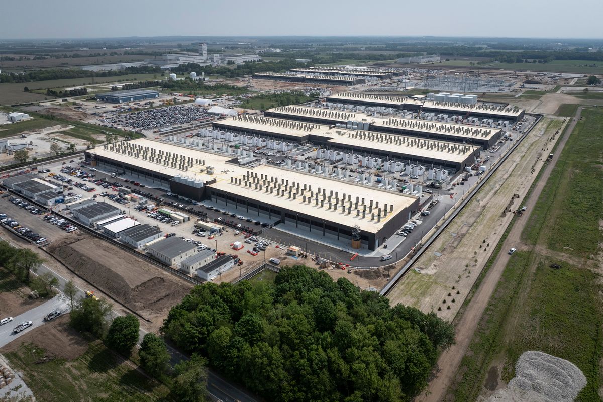 The new Amazon Web Services facility in New Carlisle, Ind., where the tech giant plans to build around 30 data centers, seen on June 3. The facility will consume 2.2 gigawatts of electricity – enough to power 1 million homes. Each year, it will use millions of gallons of water. It was built with a single customer in mind: AI start-up Anthropic, which aims to create an AI system that matches the human brain. (New York Times)