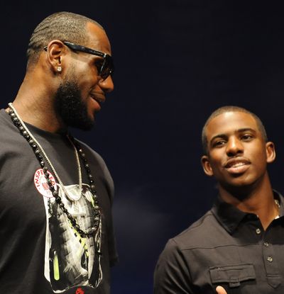 LeBron James, left, chats with Chris Paul. The MVP is unsure if Cleveland Cavaliers owner Dan Gilbert ever cared about him. (Associated Press)