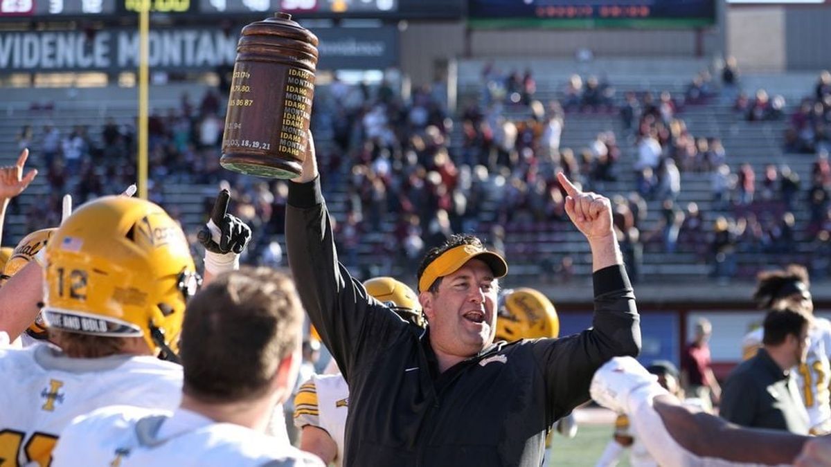 Idaho Vandals coach Jason Eck raises the Little Brown Stein rivalry trophy after beating Montana last season in Missoula. The stein came home with the Vandals to Moscow for the first time since 1999. (Courtesy Idaho Athletics)