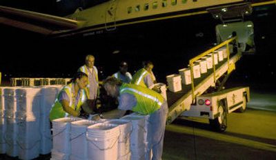 
In this photo provided by Odyssey Marine Exploration, workers unload  silver coins at an undisclosed location May 16. The coins were reportedly recovered from a yet-unidentified  shipwreck. 
 (Associated Press / The Spokesman-Review)