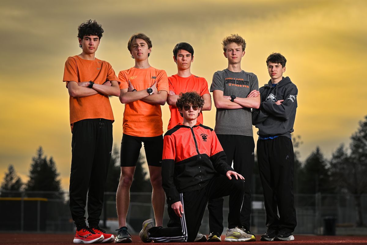 Members of the Lewis and Clark track team Harper Churape, 17, back left; Caughnery Freese, 17; Ryan Chavez, 17; Toby Meier, 16; and Parker Whitmore, 17, are pictured with teammate Brody Graham, kneeling, on Thursday.  (COLIN MULVANY/THE SPOKESMAN-REVIEW)