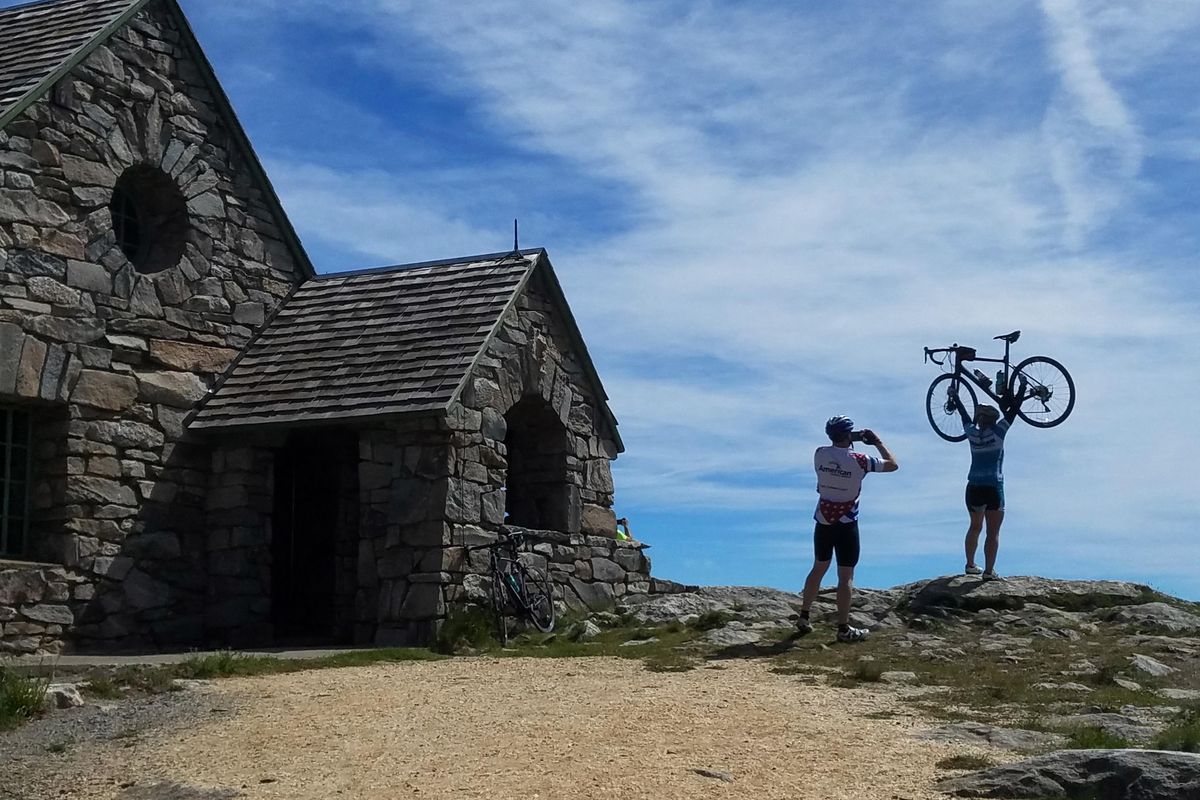 Cyclists celebrate riding the Summit Road to the Vista House near the top of Mount Spokane. In addition to pedaling, visitors can reach the 5,883-foot summit through the year by foot, horseback, snowshoe, ski, chairlift, snowmobile or other motor vehicle. (Rich Landers / The Spokesman-Review)