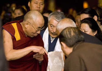 The Dalai Lama greets supporters in the lobby of the Grand Hyatt in Seattle on Thursday. Associated Press
(Associated Press / The Spokesman-Review)