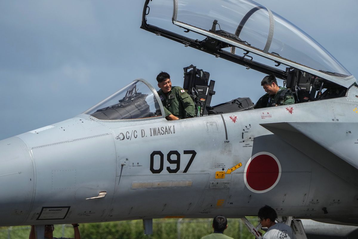 Japanese pilots refuele a F-15 fighter jet at the Tinian airport, on Feb. 17, 2023. Rattled by China
