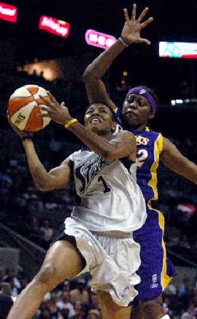 
San Antonio's Toccara Williams, drives to the hoop past Los Angeles' Nikki Teasley on Saturday. 
 (Associated Press / The Spokesman-Review)