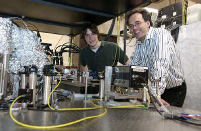 
WSU undergraduate Collin Atherton, left, and physicist Peter Engels pose with the device they built, which is the first in the Pacific Northwest capable of cooling a gas to nearly minus 459 degrees Fahrenheit and producing the rare form of matter called Bose-Einstein condensate. 
 (Courtesy of Washington State University / The Spokesman-Review)