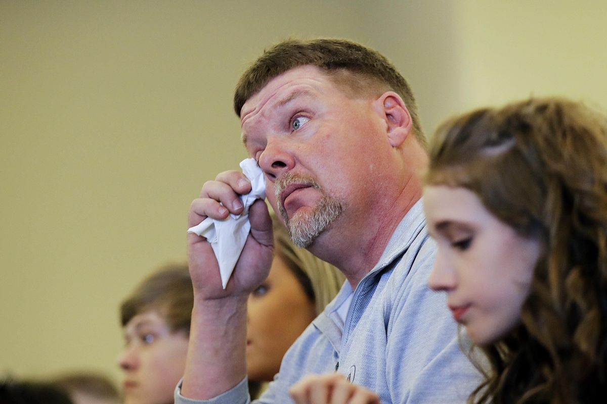 David Million wipes a tear while listening to his fiancee Kim Silvers speak at during a graduation ceremony from the Appalachian Judicial Circuit family drug court program April 11, 2017, in Ellijay, Ga2017. One of the most dramatic increases of children being taken into foster care has been in Georgia, where the foster care population soared from about 7,600 in September 2013 to more than 13,300 this spring. (David Goldman / AP)