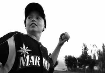 
Ross Muelheim, 10, pitches to his dad in Webster Park on Friday, before he and his family  head to Seattle where he will throw out the first pitch for tonight's Mariners game against the Angels. Muelheim is a cancer patient, and Premera Blue Cross will be sponsoring the pitch. 
 (Jed Conklin / The Spokesman-Review)