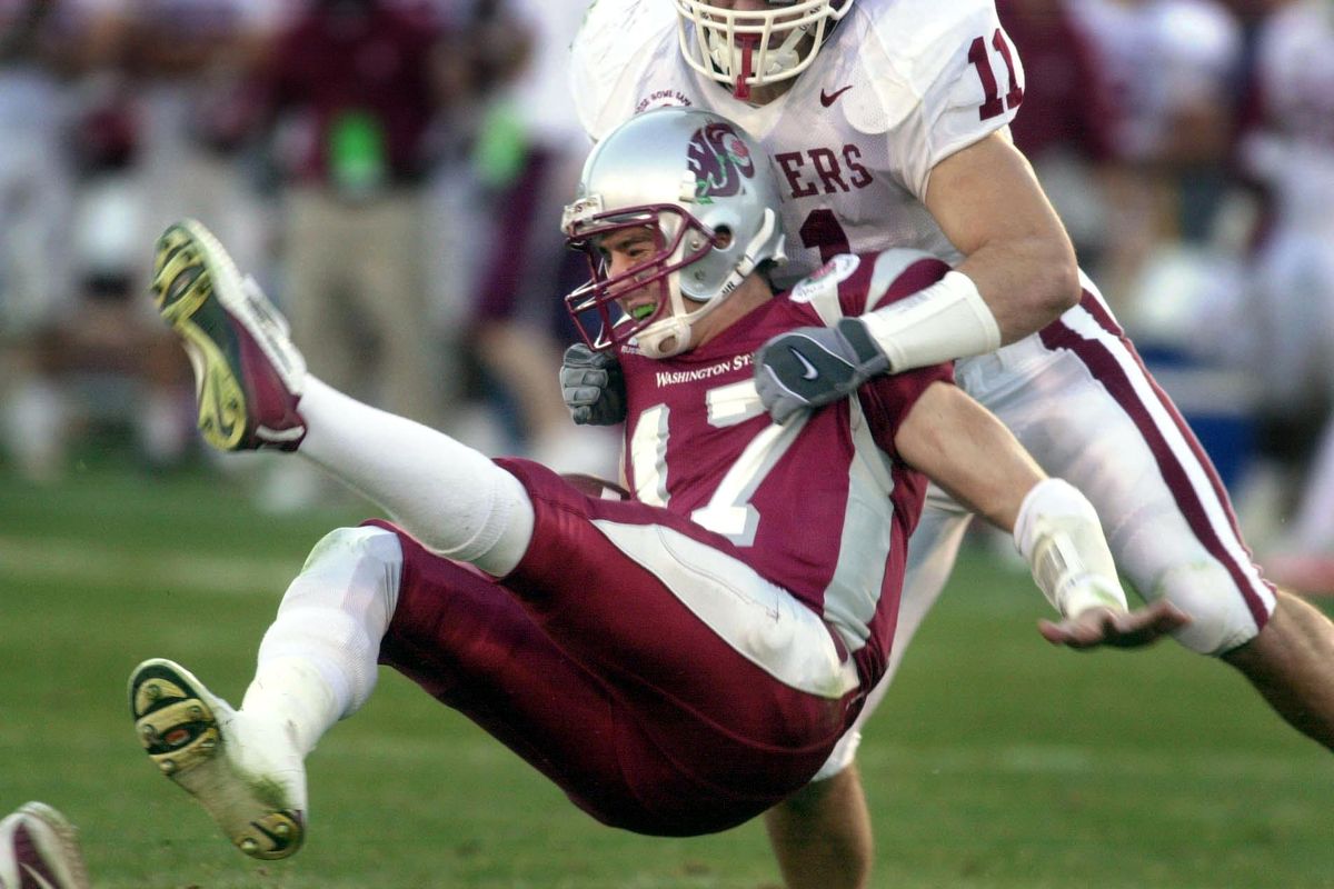 WSU quarterback Jason Gesser gets sacked by OU linebacker Teddy Lehman during the Rose Bowl NCAA football game on Wednesday, Jan. 1, 2003 in Pasadena, Calif. (Kevin German / The Spokesman-Review)