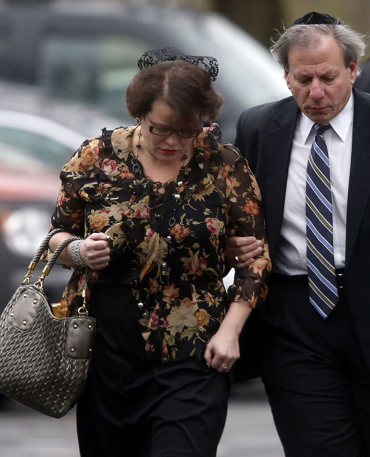 Veronique Pozner is escorted to her car after a funeral service for her 6-year-old son Noah Pozner, Monday, Dec. 17, 2012, in Fairfield, Conn. Noah Pozner was killed when gunman Adam Lanza walked into Sandy Hook Elementary School in Newtown Friday and opened fire, killing 26 people, including 20 children, before killing himself. (Jason Decrow / Fr103966 Ap)