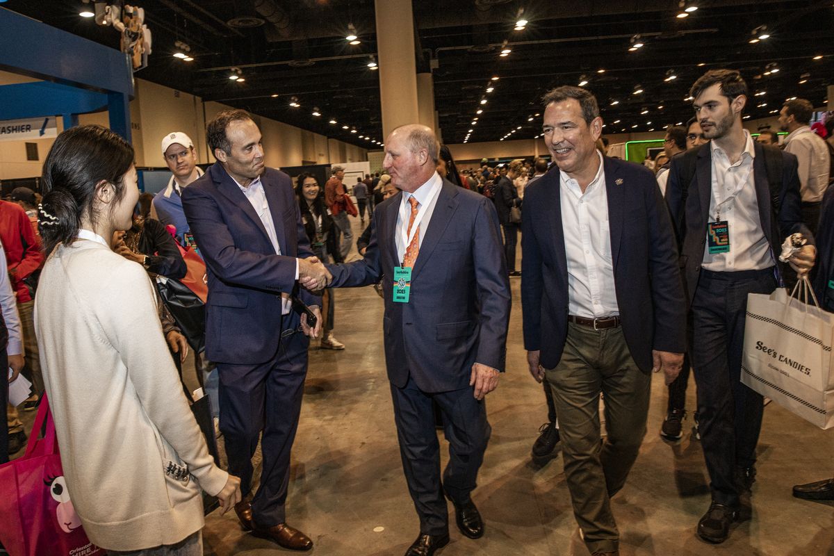 Greg Abel, chairman and chief executive officer of Berkshire Hathaway Energy Co., center, greets attendees during a shareholders shopping day ahead of the Berkshire Hathaway annual shareholders meeting in Omaha on Friday. (David Williams/Bloomberg)