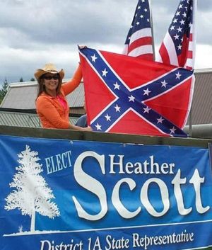 Heather Scott is shown in a photo from her legislative Facebook page holding up a Confederate flag at a Priest River celebration last year.