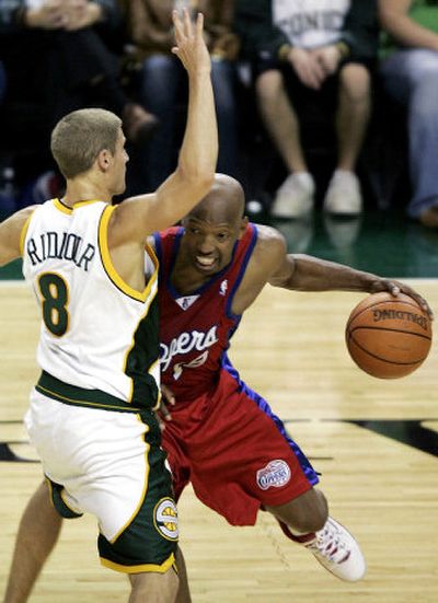 
Clippers guard Sam Cassell drives around Sonics guard Luke Ridnour in the third period.
 (Associated Press / The Spokesman-Review)