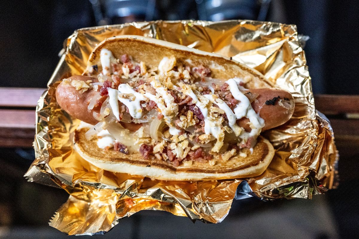 Vern Cooks food truck’s Truffleboy hot dog has sautéed onion, truffle aioli, bacon bits and fried onion for $10.  (Colin Mulvany/The Spokesman-Review)