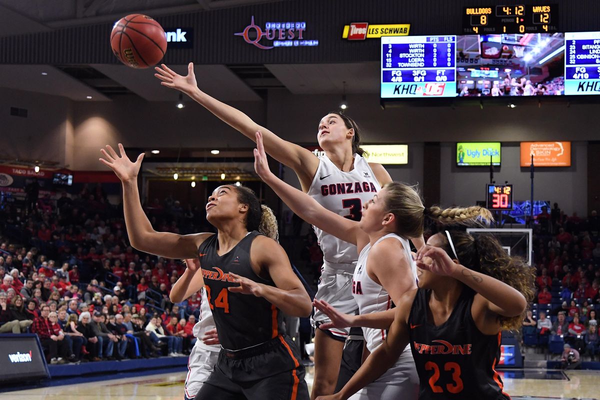 Gonzaga Bulldogs forward Jenn Wirth (3) reaches for a rebound with Pepperdine Waves forward Skye Lindsay (24) during the first half of a college basketball game, Thurs., Feb. 28, 2019, in the McCarthey Athletic Center. (Colin Mulvany / The Spokesman-Review)