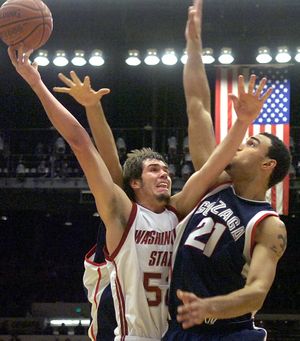 Washington State’s Caleb Forrest draws a foul from GU’s Robert Sacre.  (Christopher Anderson / The Spokesman-Review)