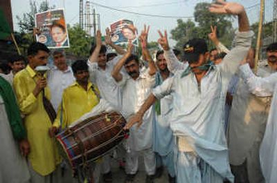 
upporters of Pakistan's ousted Prime Minister Nawaz Sharif celebrate the Supreme Court's decision in favor of their leader Thursday in Peshawar, Pakistan. Associated Press photos
 (Associated Press photo / The Spokesman-Review)