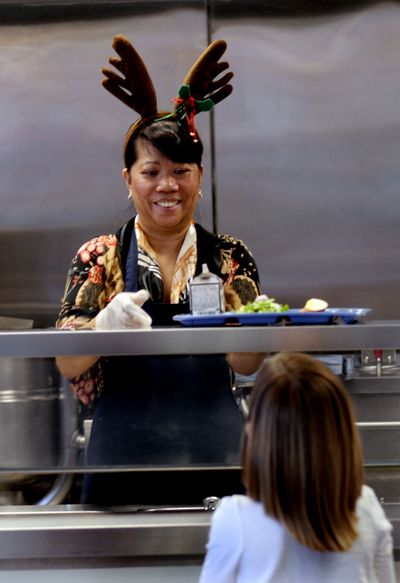 Hot lunch director Remie Burnes was in the Christmas spirit at Holy Family Catholic School as she served up the last of the lunches before Christmas break in Coeur d'Alene on Friday, December 18, 2009. (Kathy Plonka / The Spokesman-Review)