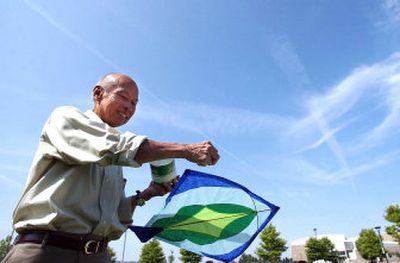 
Ron Tan takes his fighter kite up for a flight in a demonstration for children at the Parks and Recreation day camp at CenterPlace in Spokane Valley.
 (Liz Kishimoto / The Spokesman-Review)