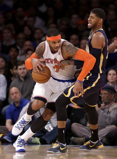 Carmelo Anthony drives past Indiana’s Paul George in the first half. (Associated Press)