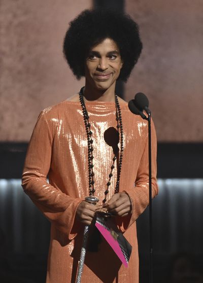 This Feb. 8, 2015, file photo shows Prince presenting the award for album of the year at the 57th annual Grammy Awards in Los Angeles. (John Shearer / Associated Press)