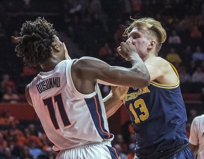 Illinois guard Ayo Dosunmu and Michigan forward Ignas Brazdeikis tangle after a foul during the second half Thursday night in Champaign, Ill., Both players were called for a technical foul. Michigan won 79-69. (Rick Danzl / Associated Press)