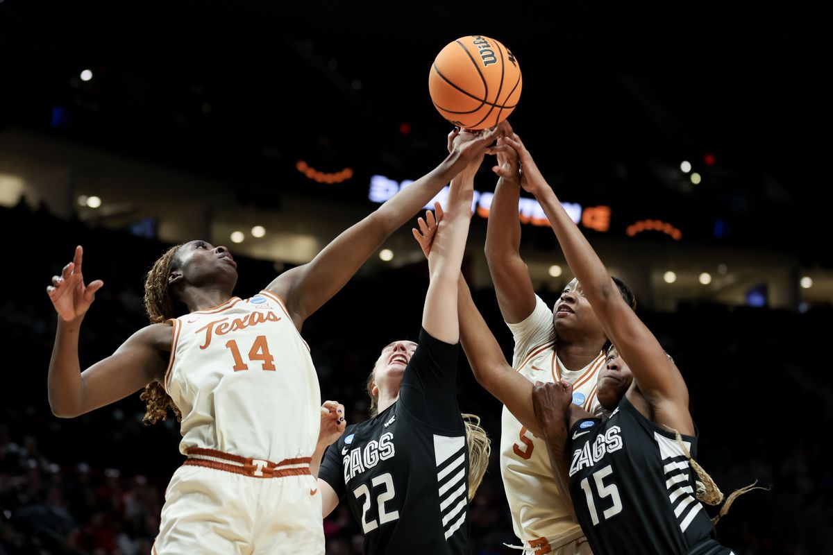 Texas’ Amina Muhammad (14) and DeYona Gaston attempt to grab a rebound over Gonzaga’s Brynna Maxwell (22) and Yvonne Ejim during the second half of Friday’s NCAA Tournament Sweet 16 game at Moda Center in Portland.  (Getty Images)