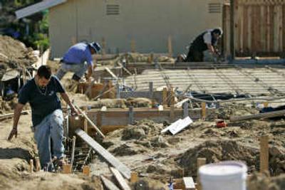 
Construction workers assemble concrete forms Tuesday at the site of a  home being built to replace one destroyed in recent wildfires in the Rancho Bernardo area of San Diego. Builders idled by the housing slump are taking single-home projects. Associated Press
 (Associated Press / The Spokesman-Review)