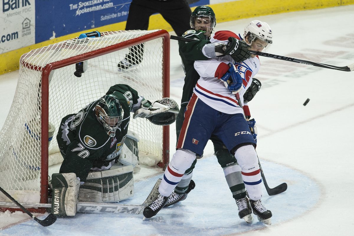Everett’s Kevin Davis (38) pulls Adam Helewka (14) of the Chiefs off-balance and away from the puck during the first overtime period. (COLIN MULVANY photos)