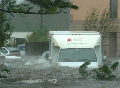 
A Red Cross truck sits flooded with other vehicles in front of a hotel just off Interstate 10 in Pascagoula, Miss., as Hurricane Katrina battered the area on Monday.
 (The Spokesman-Review)