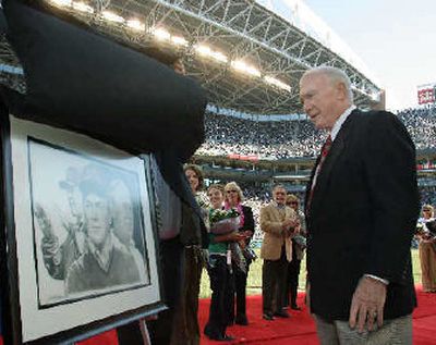 
Former Seattle Seahawks head coach Chuck Knox looks at a portrait of himself as coach during Ring of Honor ceremony. 
 (Associated Press / The Spokesman-Review)